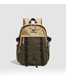 Macro view of khaki and olive green backpack showing durable nylon and elastic cord details
