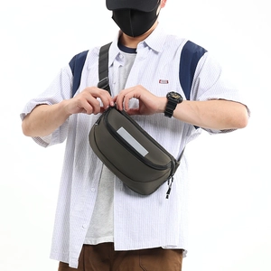 Detail view of olive green waterproof crossbody bag with high-visibility reflective strip