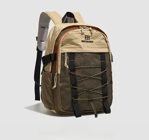 Side view of waterproof nylon backpack showing mesh pocket and bungee cord detail