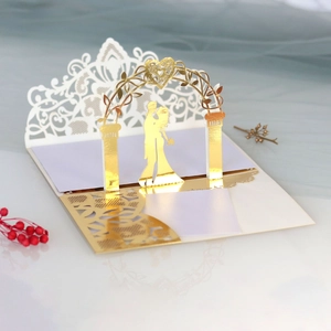 Detailed laser-cut 3D wedding invitation card with gold foil bride and groom silhouette
