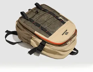 Detail view of khaki waterproof nylon backpack with top mesh pocket and drawstring closure