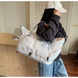 Detail view of large nylon travel bag showing the dry-wet separation bottom compartment