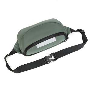 Close-up of grey-green crossbody bag with black adjustable strap and reflective strip