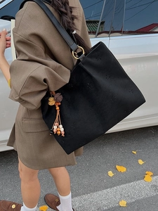 Sac seau rétro noir en daim avec motifs étoiles ajourés et pendentif à pompon
