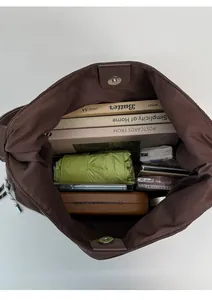 Top view of large brown tote bag showing spacious interior with books and magnetic closure