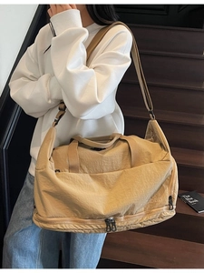 Large khaki nylon travel bag with adjustable shoulder strap for casual weekend trips