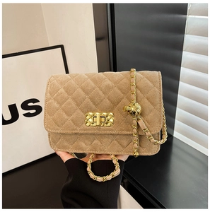 Detailed view of camel quilted suede bag with gold chain strap and metal swivel lock