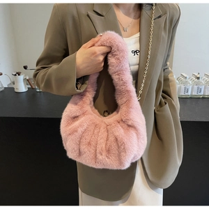 Detail of pink faux fur crossbody bag with soft plush texture and elegant pleated design