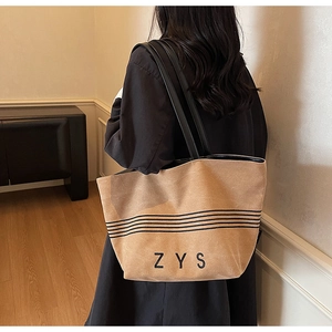 Lifestyle shot showing the khaki large capacity striped canvas tote bag size and fit
