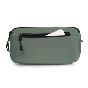 Detailed macro view of the olive green waterproof nylon crossbody bag showing zippers