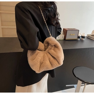 Khaki faux fur cloud bag with gold chain strap shown on model for autumn winter style