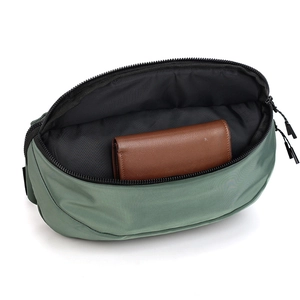 Interior view showing the large capacity of the green waterproof nylon fanny pack