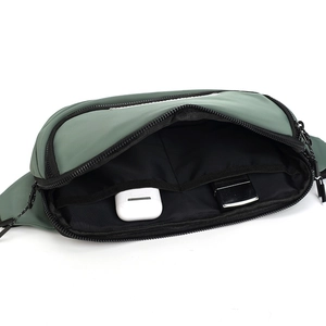 Internal view showing storage capacity of the waterproof dark green nylon crossbody bag