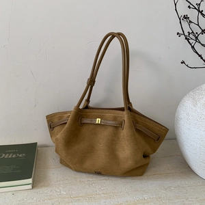 Macro detail of brown suede tote bag featuring pleated texture and thin shoulder straps
