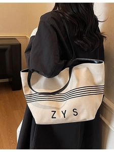 Minimalist striped canvas tote bag with large capacity and elegant black leather handles