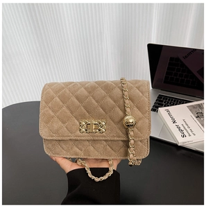 Detail of khaki quilted suede chain bag with golden twist-lock and adjustment ball
