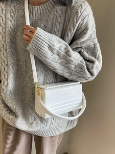Minimalist white leather handbag with magnetic buckle and golden logo for women