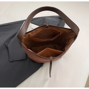 Top view of suede tote interior with zipper pocket and spacious compartments