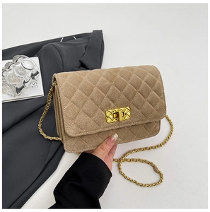 Detail of khaki quilted suede handbag with gold woven chain and textured twist lock