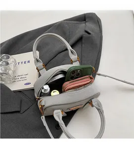 Detail view of large interior capacity of grey pebble leather bowling shoulder bag