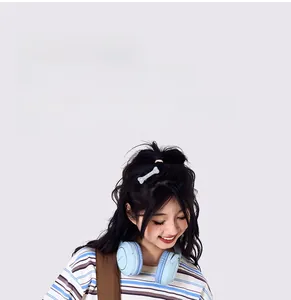Detail of adjustable wide brown shoulder strap and stylish light blue wireless headphones