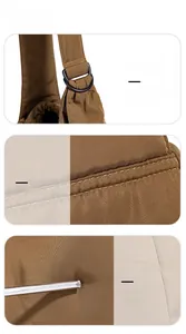 Detail shot of brown nylon tote showing metal D-ring hardware and durable stitching