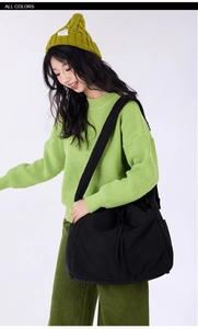 Detail of black drawstring tote bag showing durable nylon material and adjustable strap