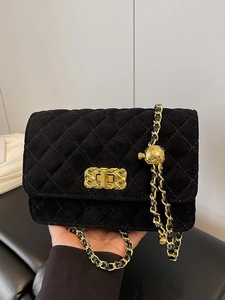 Elegant black quilted suede crossbody bag with gold chain strap and metal ball adjuster