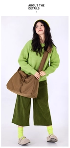 Detail of a large capacity brown crossbody bag with drawstring closure and soft texture