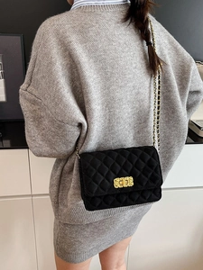 Chic black quilted chain crossbody bag with golden rectangular turn-lock closure