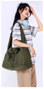 Detail of army green nylon drawstring crossbody bag with wide shoulder strap design