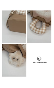 Detailed views of brown leather bag with plaid fabric trim and star plush charm