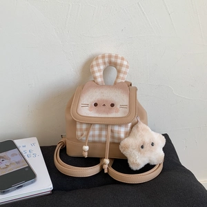 Detail of beige mini backpack with cartoon cat print, checkered handle and plush star charm