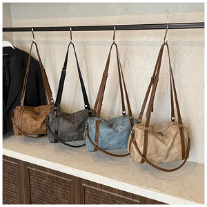 Detail view of large capacity boston pillow bags in four vintage colors with soft texture