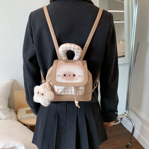 Detail of khaki leather mini backpack with cartoon cat embroidery and star pendant