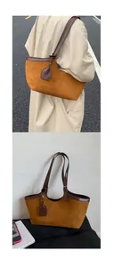 Detail of vintage brown suede tote bag with leather piping and adjustable shoulder strap