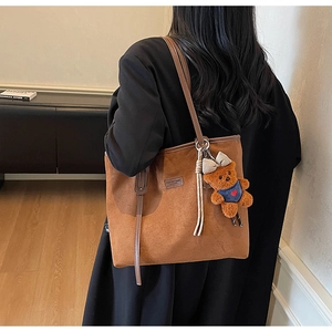 Brown frosted large tote bag detail featuring a cute bear pendant and sleek shoulder strap
