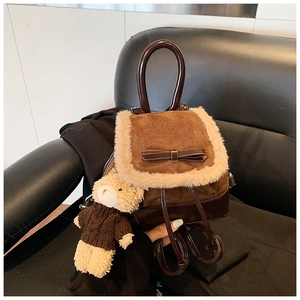Detail of caramel mini backpack with fuzzy trim, bow, and cute teddy bear charm