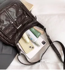 Detail view of multi-compartment soft leather crossbody bag with spacious interior capacity