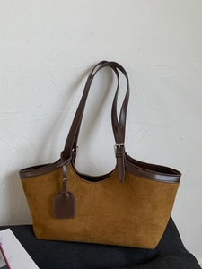 Minimalist dark brown suede tote bag with adjustable handles for shoulder or hand carry