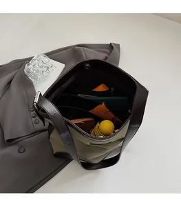 Interior view showing large capacity and multi-compartment storage in woven tote bag