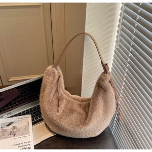 Detail of soft khaki plush crescent bag showing fuzzy texture and leather strap in sunlight
