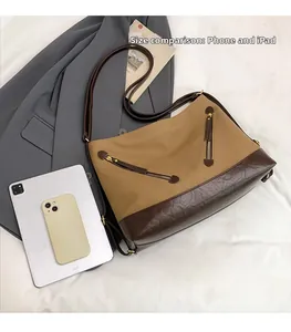 Top view of large canvas tote bag showing interior space compared with an iPad and phone