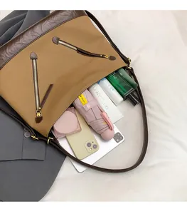 Detail shot of large canvas bucket bag interior showing tablet, phone and umbrella