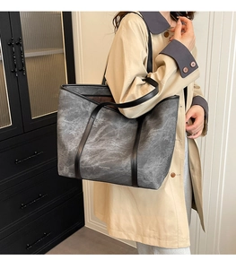 Detail view of large tote bag featuring marble texture and FOJY & BAGS branding
