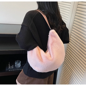 Detail showing plush pink faux fur texture and crescent shape of the casual shoulder bag