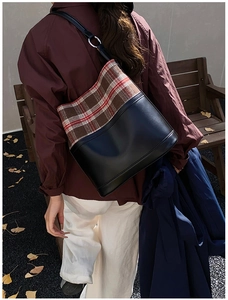 Detail of a vintage plaid stitching shoulder bag showing premium leather texture