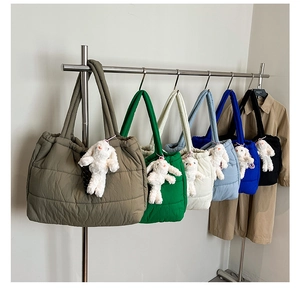 Detailed row of quilted puffer tote bags with plush rabbit charms in multiple colors