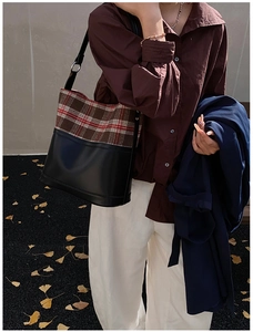 Fashionable crossbody bag featuring classic plaid stitching and black leather trim for women