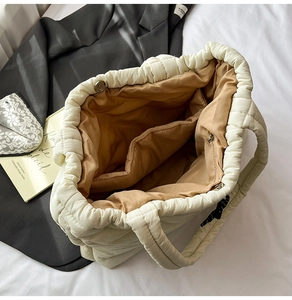 Top view of beige quilted puffer tote bag showing inner compartments and magnetic closure